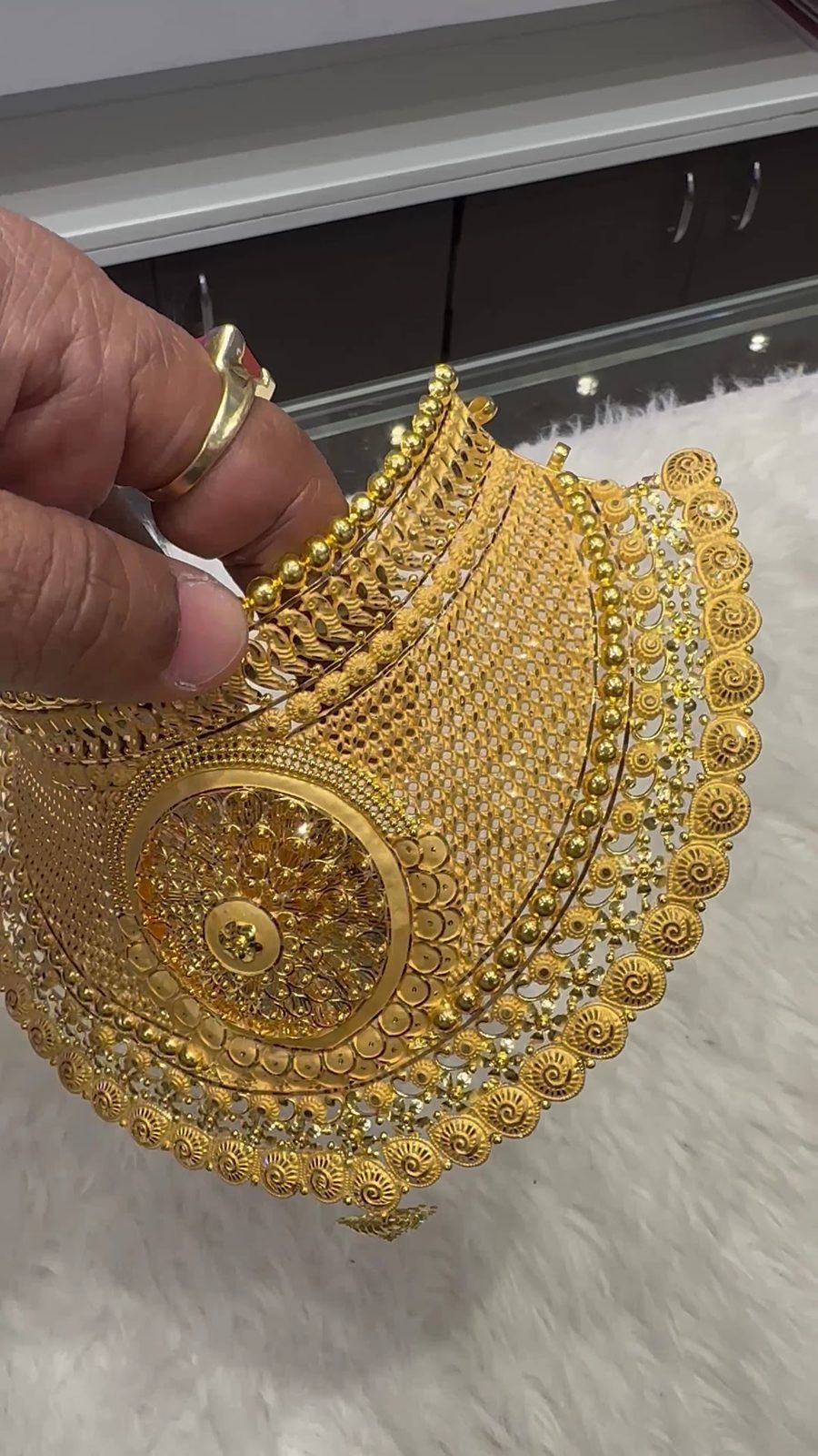 Gold choker held at the counter