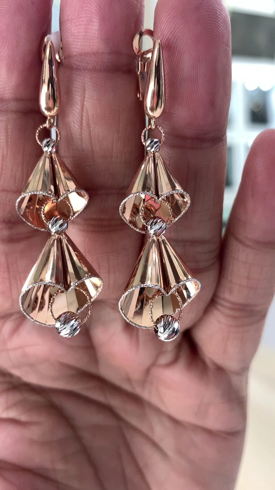 Rose-gold fluted earrings in the palm
